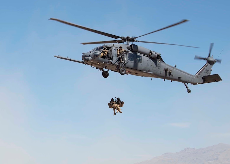 The 66th Rescue Squadron rappel from an HH-60G Pave Hawk helicopter