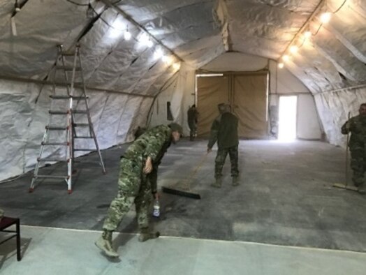 Personnel from the 332nd Expeditionary Logistics Readiness Squadron prep the new passenger service terminal March 2019, Southwest Asia in support of Operation Inherent Resolve. A proper facility was required to ensure proper accountability for all deploying into and out of the base, while allowing U.S. Customs to inspect cargo in a timely manner. (Courtesy photo)