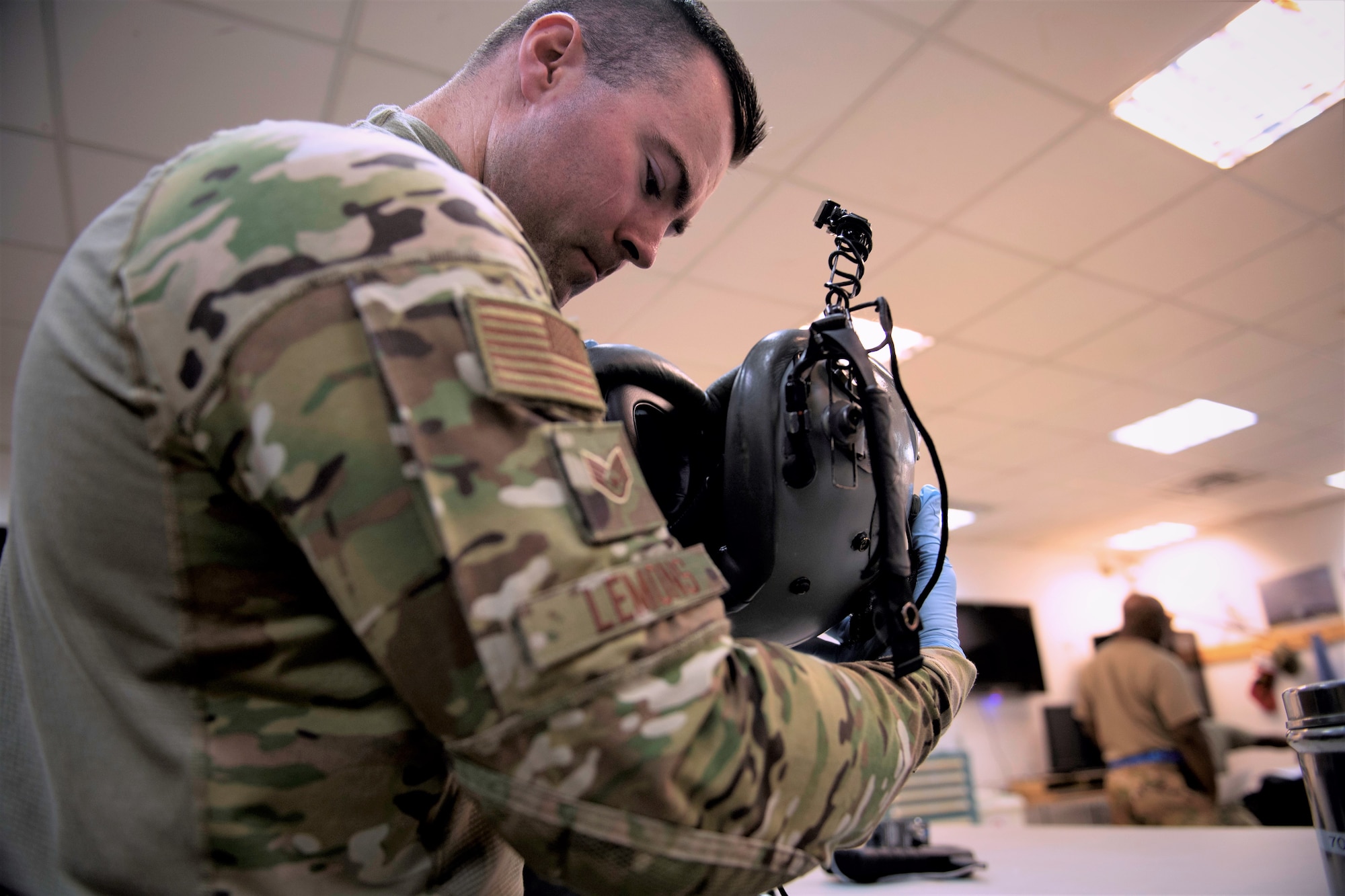 U.S. Air Force Staff Sgt. Zane Lemons, 779th Expeditionary Airlift Squadron aircrew flight equipment journeyman, inspects a flight helmet before certifying it for in-flight operations on Ali Al Salem Air Base, Kuwait, July 3, 2019. Aircrew flight equipment technicians provide vital life support equipment for aircrew members traveling around the U.S. Central Command area of responsibility. Lemons is deployed from the 120th Airlift Wing, Montana Air National Guard. (U.S. Air Force photo by Tech. Sgt. Michael Mason)