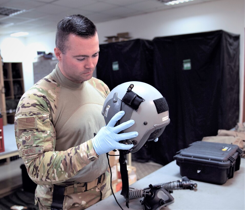 U.S. Air Force Staff Sgt. Zane Lemons, 779th Expeditionary Airlift Squadron aircrew flight equipment journeyman, inspects a flight helmet before certifying it for in-flight operations on Ali Al Salem Air Base, Kuwait, July 3, 2019. Aircrew flight equipment technicians provide vital life support equipment for aircrew members traveling around the U.S. Central Command area of responsibility. Lemons is deployed from the 120th Airlift Wing, Montana Air National Guard. (U.S. Air Force photo by Tech. Sgt. Michael Mason)