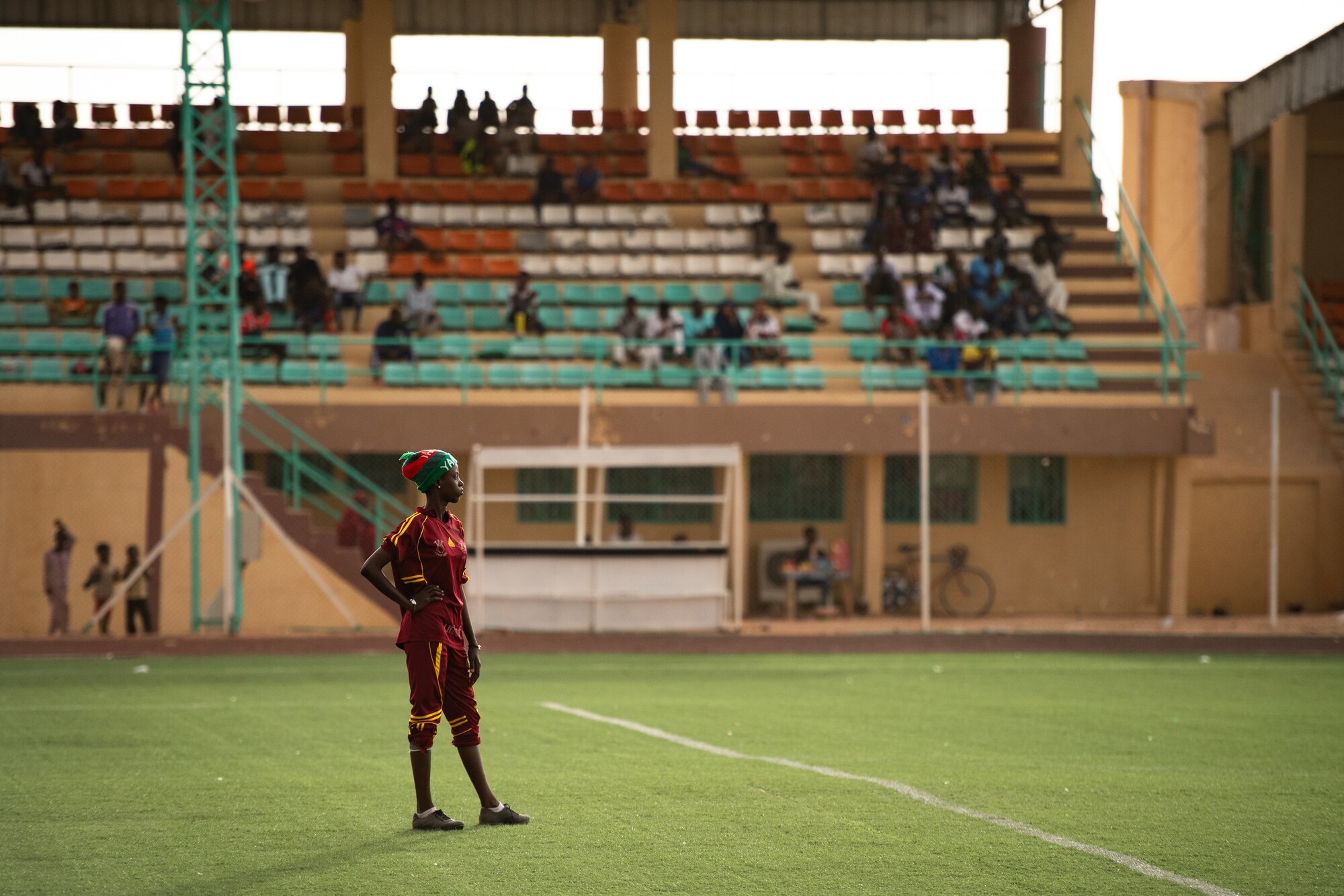 The goalie for the Nassara Athletic Club Women’s Soccer Team observes the opposite side of the field during a recreational game between Nigerien Air Base 201 and the Nassara Athletic Club Women’s Soccer Team at the Agadez Sports Stadium in Agadez, Niger, July 5, 2019. The civil affairs team held the game to build rapport and promote positive sentiment between the local community and AB 201 personnel. (U.S. Air Force photo by Staff Sgt. Devin Boyer)