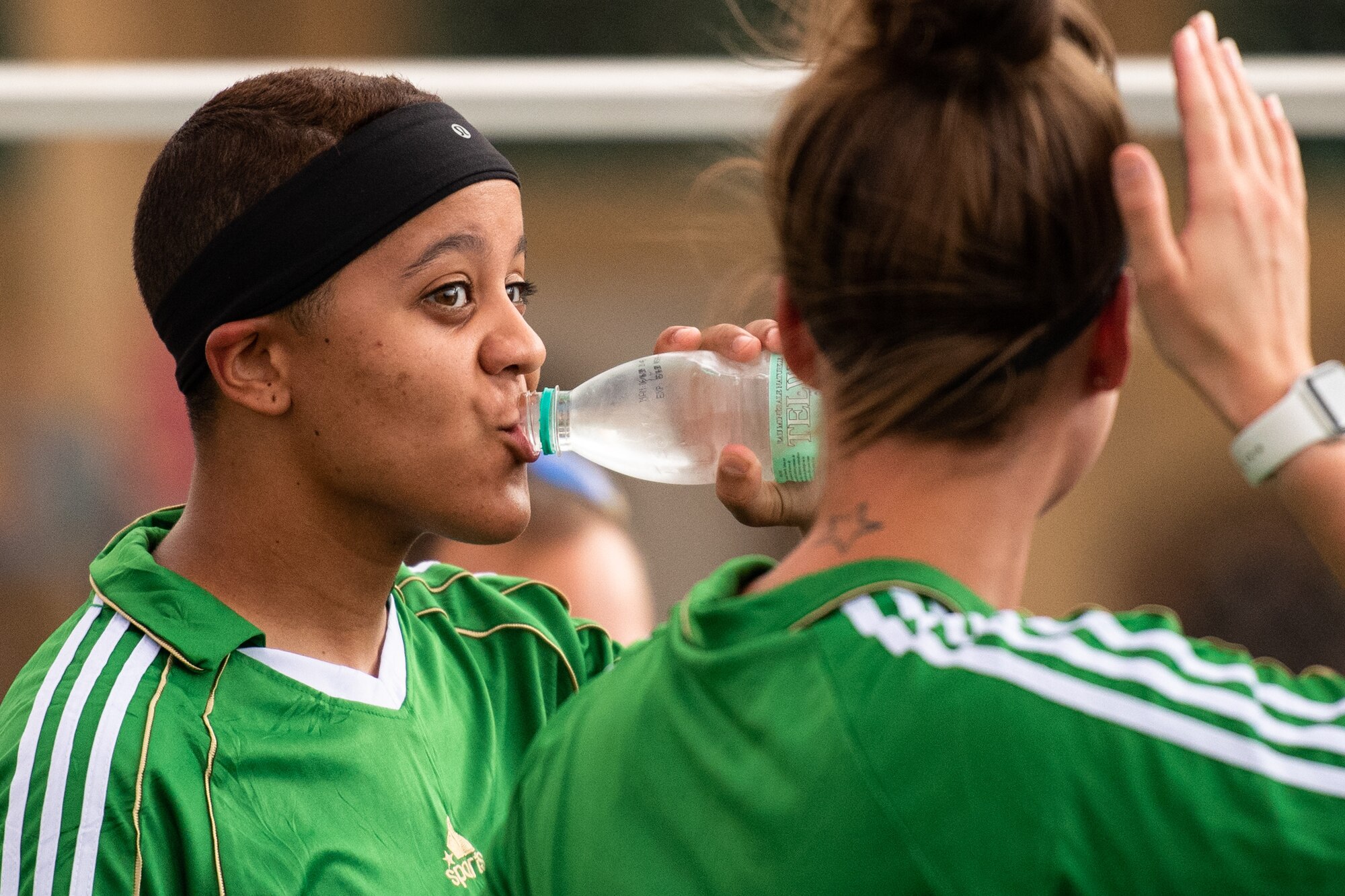 U.S. Air Force Senior Airman Lexis French, 724th Expeditionary Air Base Squadron services member, drinks water during a recreational game between Nigerien Air Base 201 and the Nassara Athletic Club Women’s Soccer Team at the Agadez Sports Stadium in Agadez, Niger, July 5, 2019. The civil affairs team held the game to build rapport and promote positive sentiment between the local community and AB 201 personnel. (U.S. Air Force photo by Staff Sgt. Devin Boyer)