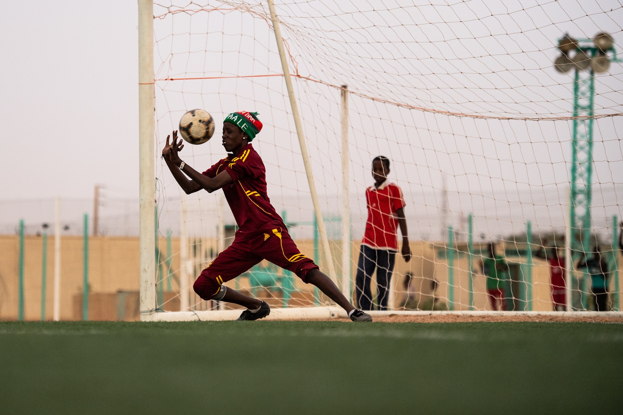 The goalie for the Nassara Athletic Club Women’s Soccer Team attempts to block a goal during a recreational game between Nigerien Air Base 201 and the Nassara Athletic Club Women’s Soccer Team at the Agadez Sports Stadium in Agadez, Niger, July 5, 2019. The civil affairs team held the game to build rapport and promote positive sentiment between the local community and AB 201 personnel. The game ended with a three on three shootout resulting in AB 201’s victory. (U.S. Air Force photo by Staff Sgt. Devin Boyer)