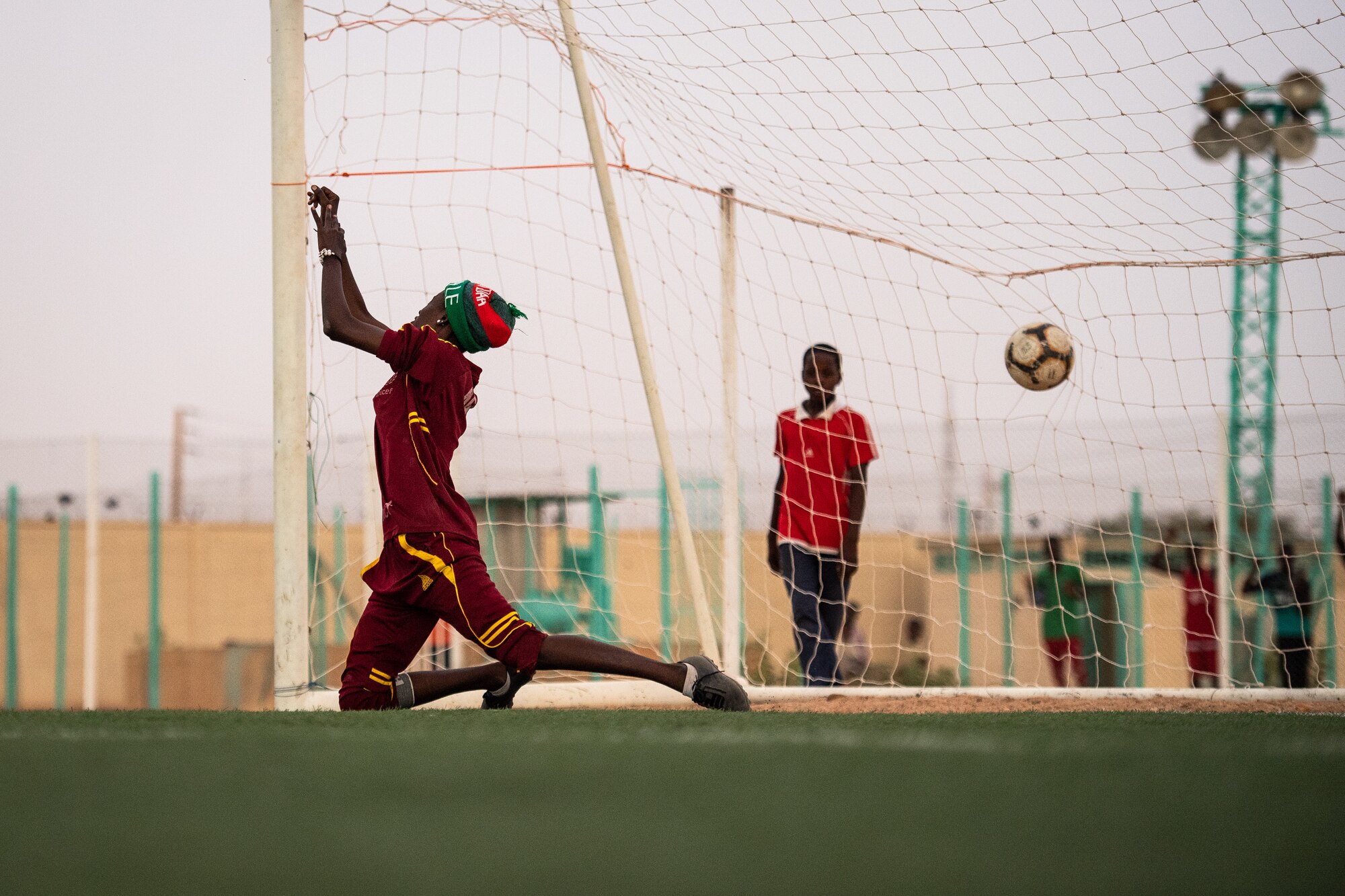 The goalie for the Nassara Athletic Club Women’s Soccer Team misses the ball while blocking during a recreational game between Nigerien Air Base 201 and the Nassara Athletic Club Women’s Soccer Team at the Agadez Sports Stadium in Agadez, Niger, July 5, 2019. The civil affairs team held the game to build rapport and promote positive sentiment between the local community and AB 201 personnel. The game ended with a three on three shootout resulting in AB 201’s victory. (U.S. Air Force photo by Staff Sgt. Devin Boyer)