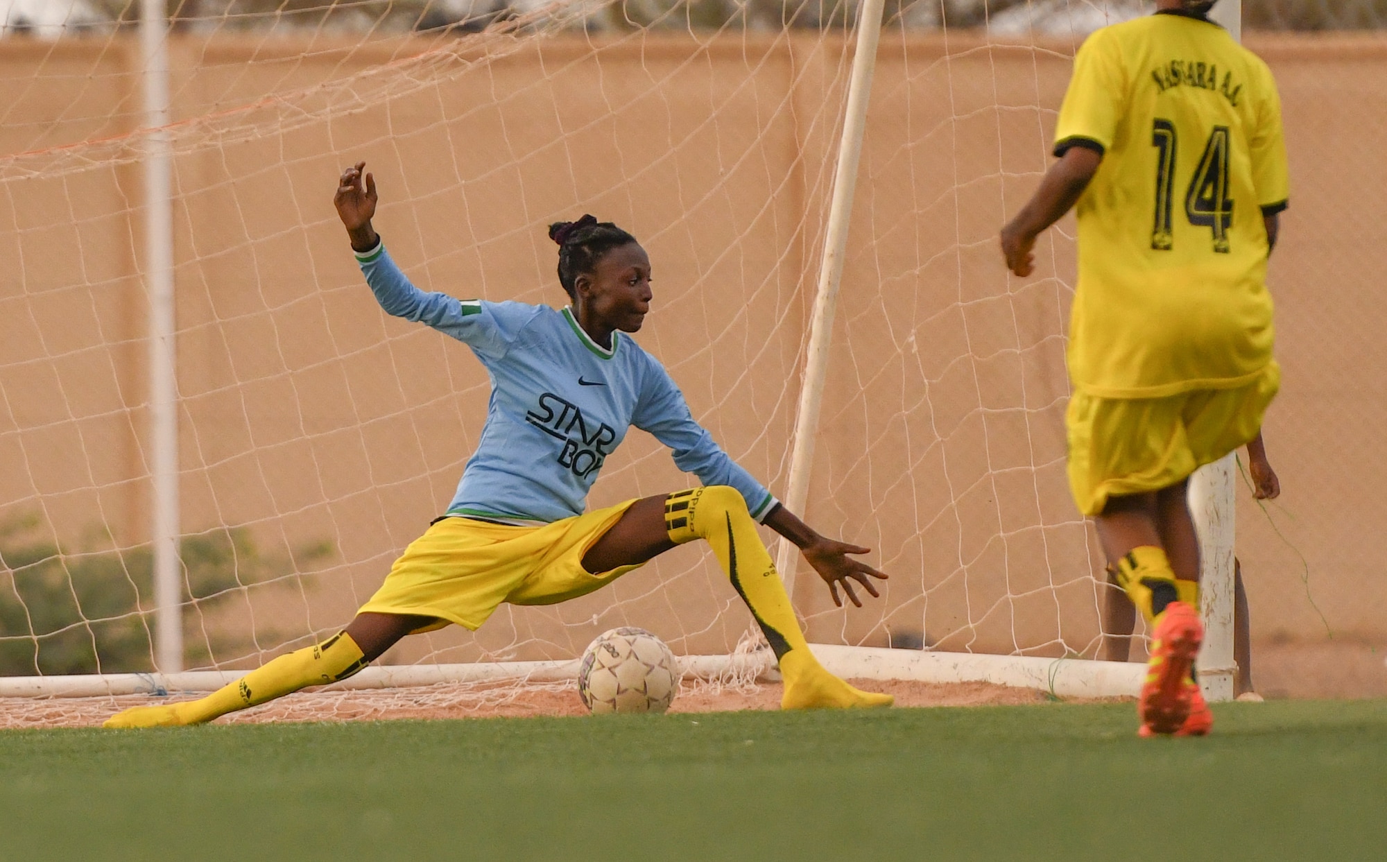 A player from the Nassara Athletic Club Women’s Soccer Team stretches to block a goal during a soccer game against U.S. Air Force women from Nigerien Air Base 201 at the Agadez Sports Stadium in Agadez, Niger, July 5, 2019. The civil affairs team held the game to build rapport and promote positive sentiment between the local community and AB 201 personnel.  (U.S. Air Force photo by Senior Airman Lexie West)
