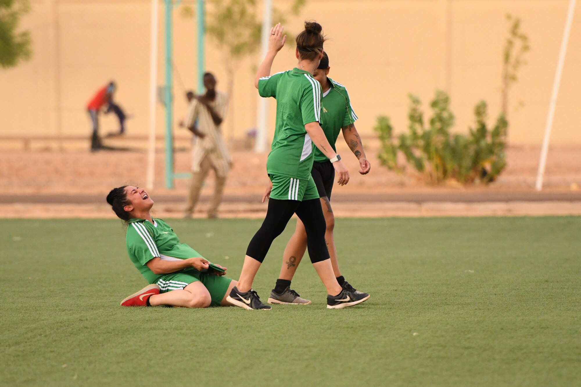 U.S. Air Force Airman First Class Alex Ferrero, 724th Expeditionary Air Base Squadron security forces member, celebrates after scoring a goal during a soccer game against the Nassara Athletic Club Women’s Soccer Team at the Agadez Sports Stadium in Agadez, Niger, July 5, 2019. The civil affairs team held the game to build rapport and promote positive sentiment between the local community and Nigerien Air Base 201 personnel.  (U.S. Air Force photo by Senior Airman Lexie West)