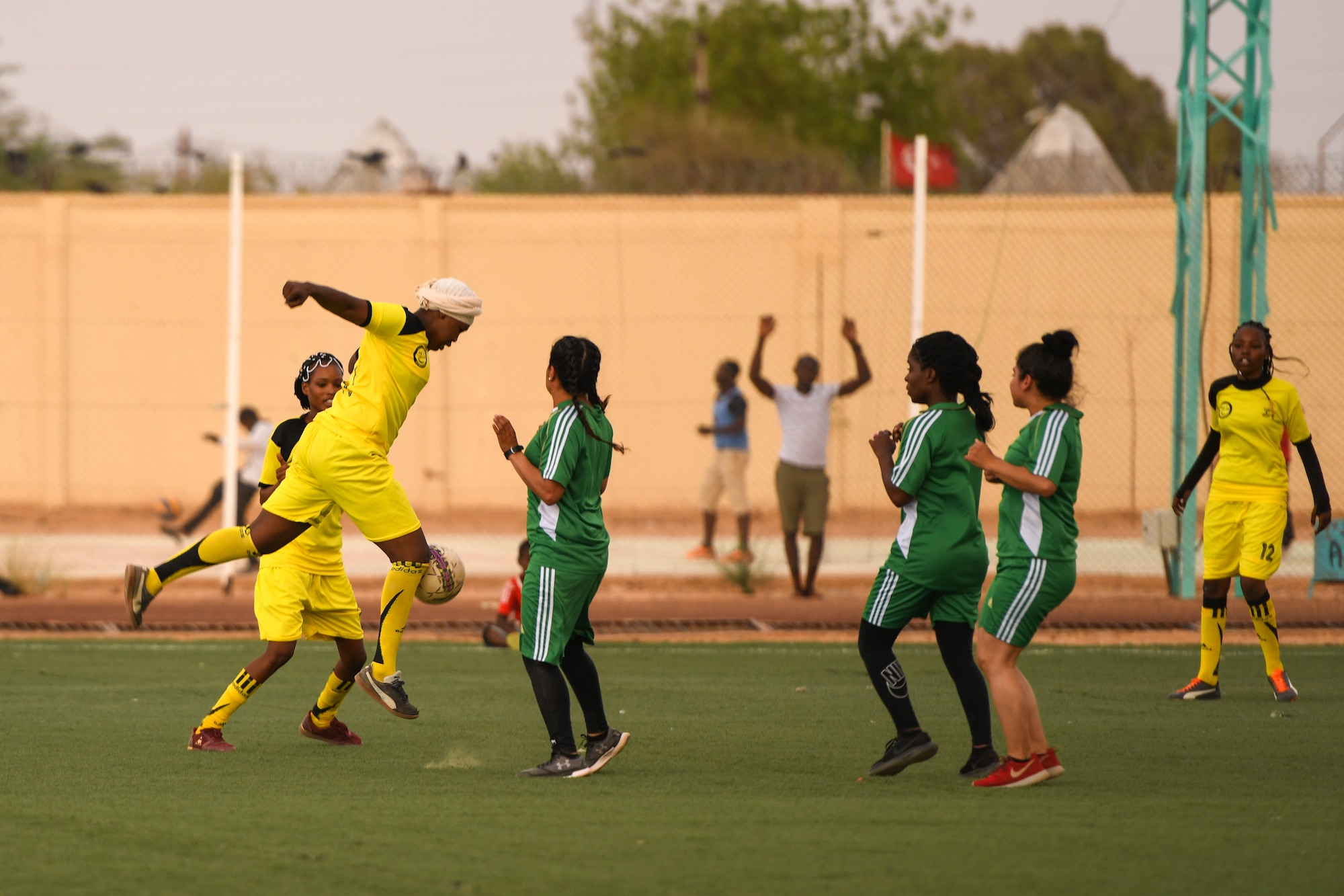 A player from the Nassara Athletic Club Women’s Soccer Team knees a soccer ball during a game against U.S. Air Force women from Nigerien Air Base 201 at the Agadez Sports Stadium in Agadez, Niger, July 5, 2019. The civil affairs team held the game to build rapport and promote positive sentiment between the local community and AB 201 personnel.  (U.S. Air Force photo by Senior Airman Lexie West)