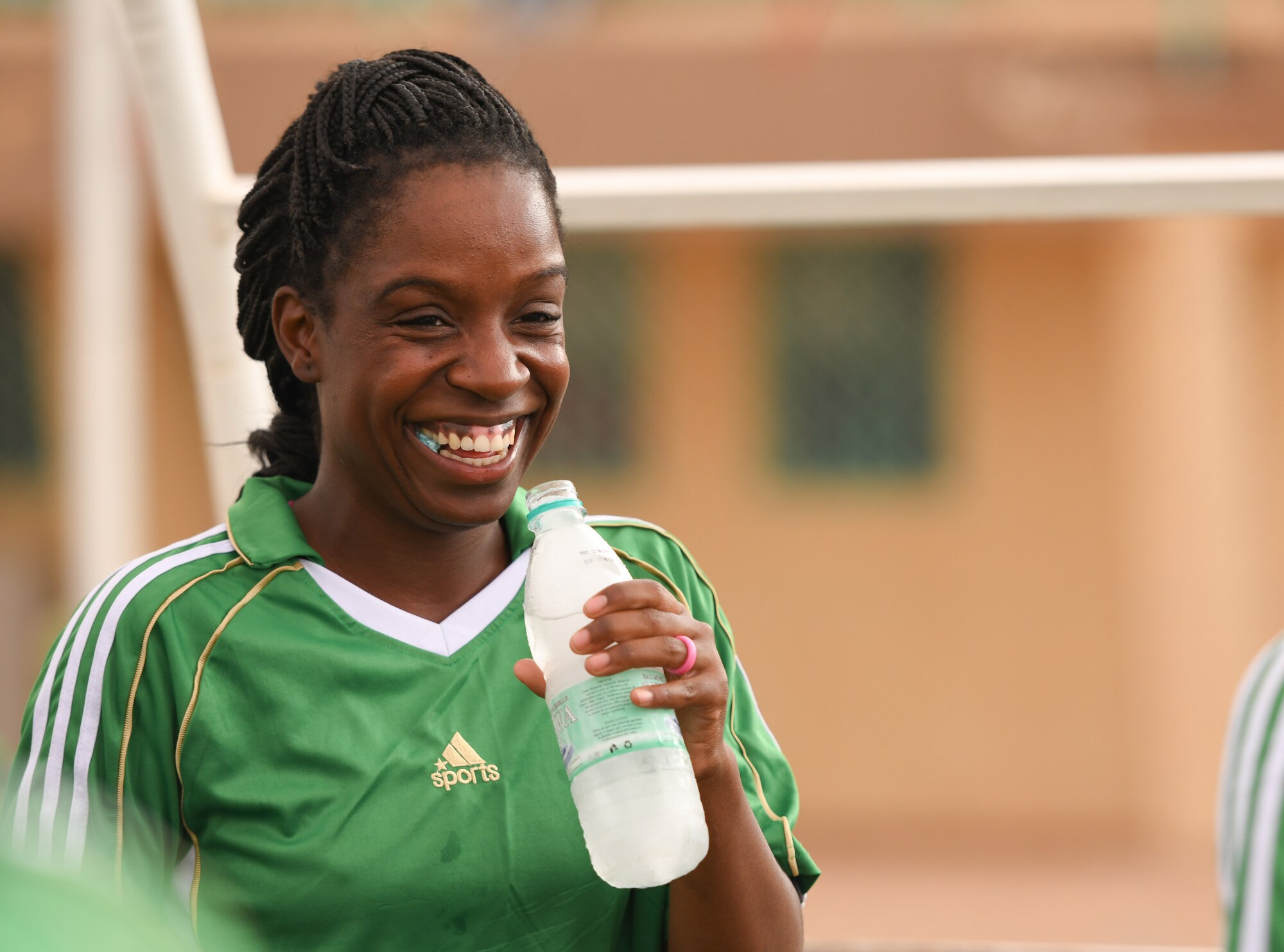 U.S. Air Force Staff Sgt. Chelsie Suggs, 724th Expeditionary Air Base Squadron security forces member, smiles after talking to fellow teammates during a soccer game against the Nassara Athletic Club Women’s Soccer Team at the Agadez Sports Stadium in Agadez, Niger, July 5, 2019. The civil affairs team held the game to build rapport and promote positive sentiment between the local community and Nigerien Air Base 201 personnel. (U.S. Air Force photo by Senior Airman Lexie West)