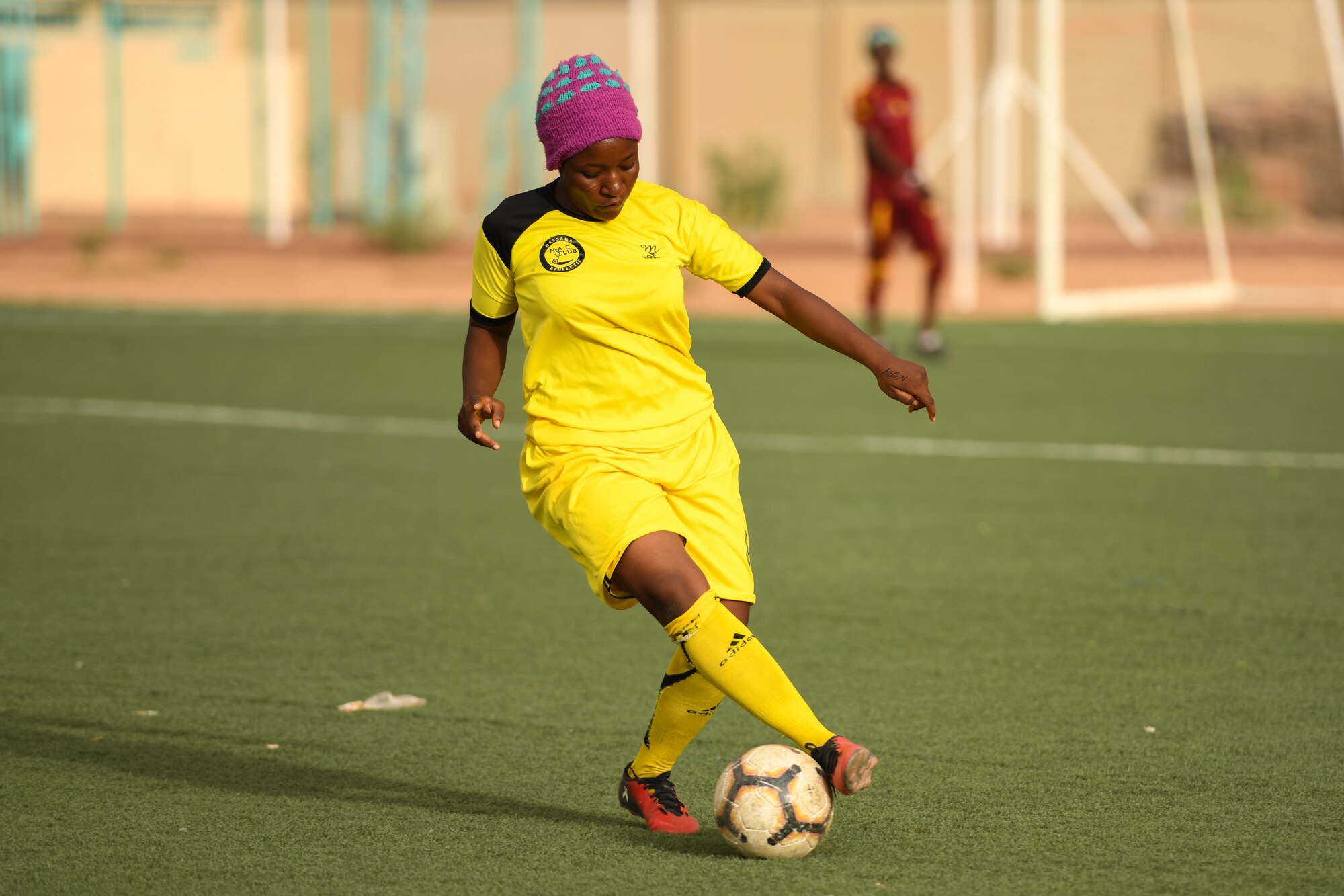 A player from the Nassara Athletic Club Women’s Soccer Team maneuvers a soccer ball during a game against U.S. Air Force women from Nigerien Air Base 201 at the Agadez Sports Stadium in Agadez, Niger, July 5, 2019.  The civil affairs team organized the community outreach event that also included the donation of soccer balls to the women’s team and youth development team. (U.S. Air Force photo by Senior Airman Lexie West)