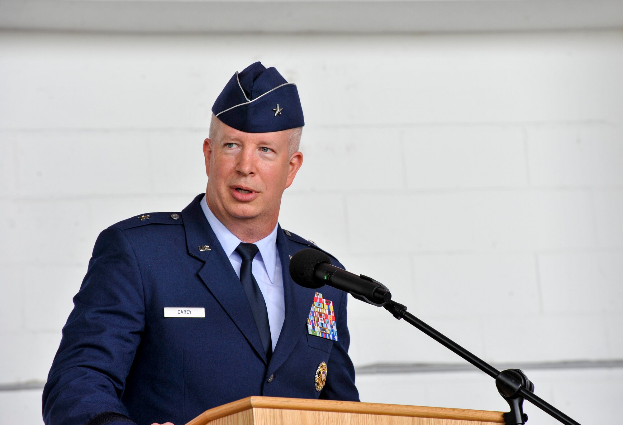 U.S. Air Force Brig. Gen. Joel Carey, 18th Wing commander, addresses the audience of the 18th Wing during a change of command ceremony July 8, 2019, at Kadena Air Base, Japan.