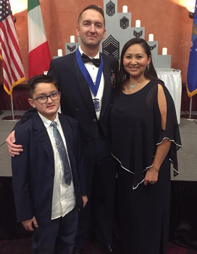 U.S. Air Force Senior Master Sgt. Jeremy Schoneboom, first sergeant of the 31st Security Forces Squadron from Aviano Air Base, Italy, poses for a picture with his wife and son. (Courtesy Photo)
