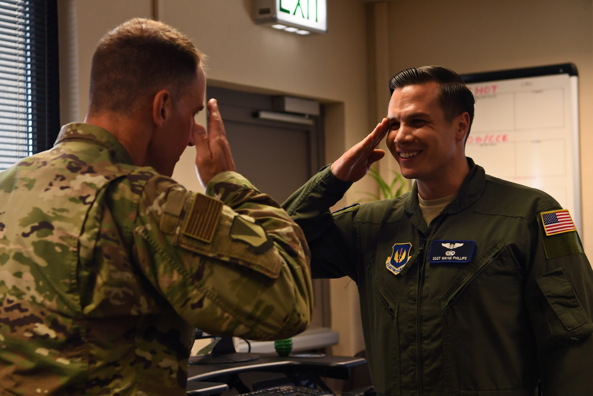 U.S. Air Force Staff Sgt. Wayne Phillips, 76th Airlift Squadron flight attendant, salutes U.S. Air Force Col. Matthew Husemann, 86th Airlift Wing vice commander, at the 76th Airlift Squadron headquarters building on Ramstein Air Base, Germany, June 27, 2019. Phillips was recognized as the 86th Airlift Wing’s Airlifter of the Week. (U.S. Air Force photo by Staff Sgt. Nesha Stanton)