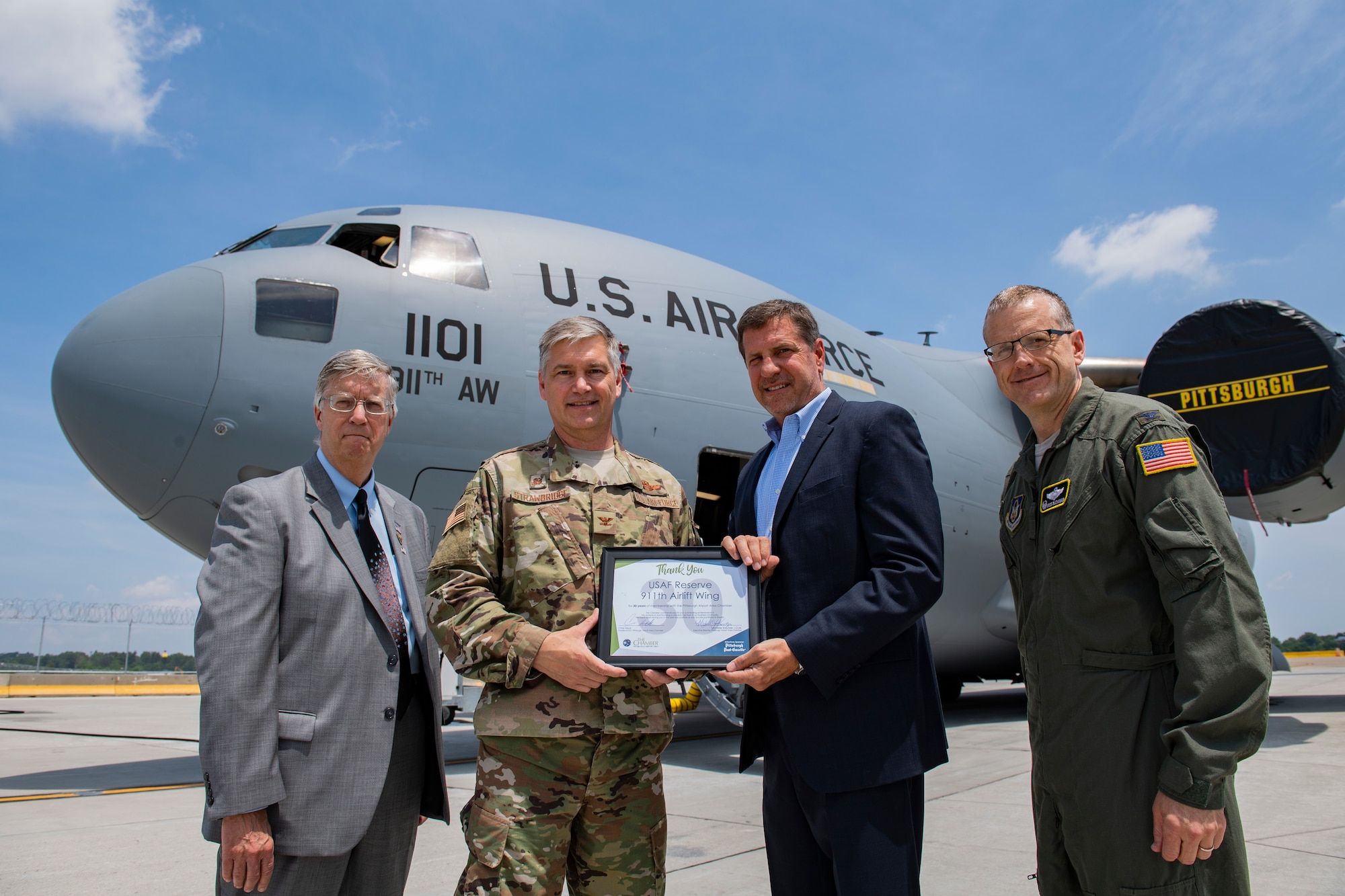 Col. Douglas Strawbridge, commander of the 911th Airlift Wing, receives a certificate from Chris Heck, President/CEO of the Pittsburgh Airport Area Chamber of Commerce, joined by Doug Keeter, Membership Director of the PAACC, and Col. Gregory Buchanan, commander of the 911th Operations Group, at the Pittsburgh International Airport Air Reserve Station, Pa., June 28, 2019. The certificate recognizes the 911th AW’s 30 years of membership with the PAACC, a nonprofit organization which pledges to advance economic vitality by providing advocacy, information and services to their members and the business community. (U.S. Air Force photo by Joshua J. Seybert)