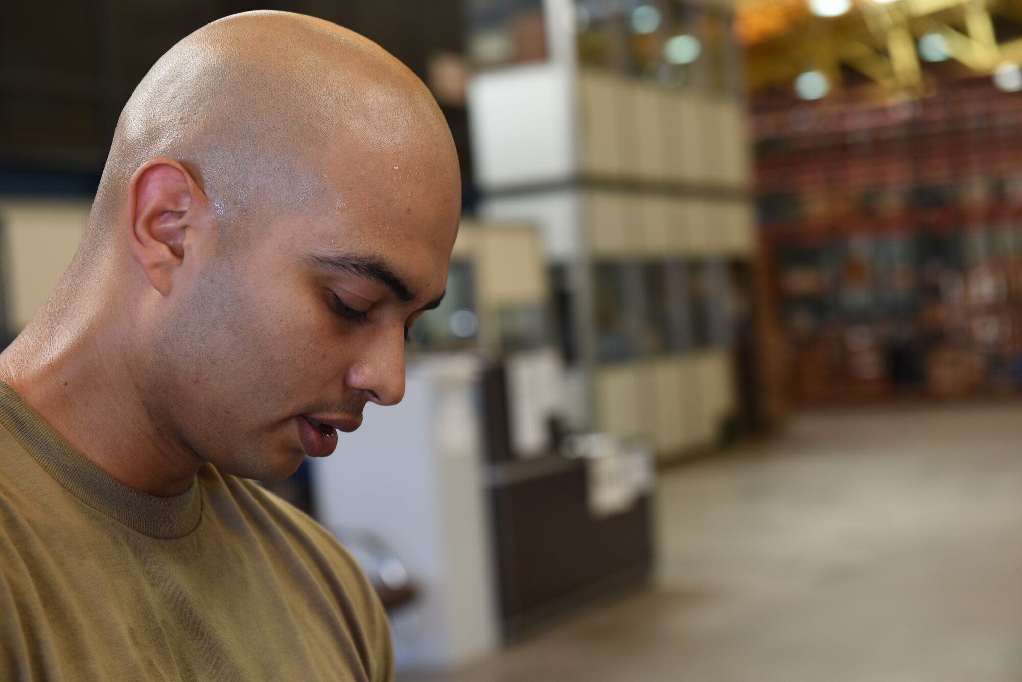 Photo of Staff Sgt. Raul Balderas prepares equipment for mobility bags.