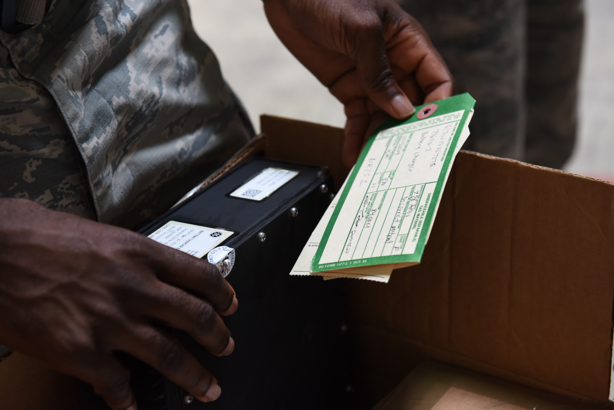 Photo of Senior Airman Dennis Smith reviewing an aircraft part ticket.