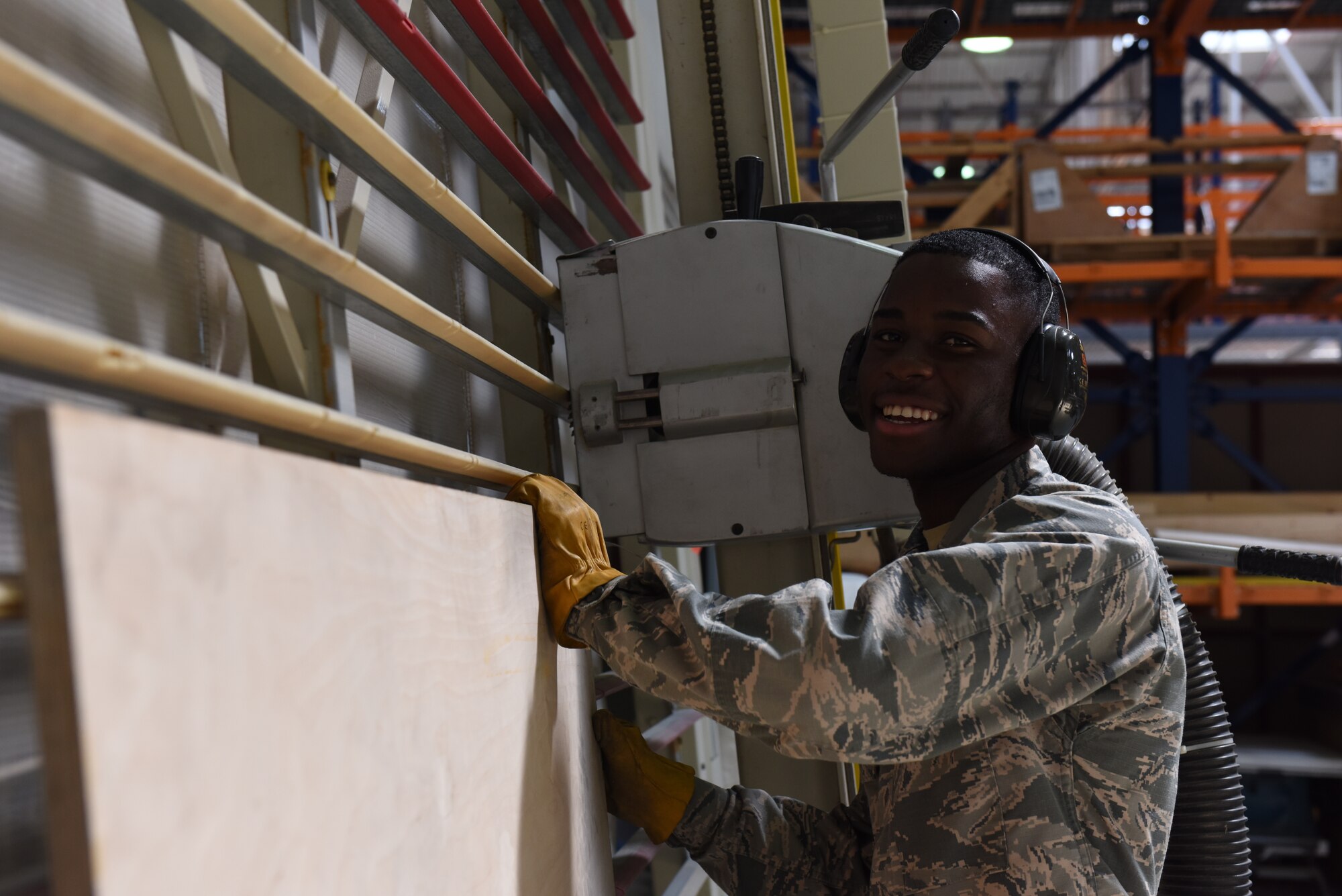 Photo of Airman Kokou Daglo cutting a board.