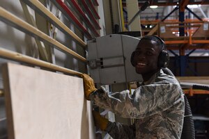 U.S. Airman Kokou Daglo, 39th Logistics Readiness Squadron inbound cargo journeyman, prepares to cut a board June 25, 2019, at Incirlik Air Base, Turkey. Along with inspecting items to determine serviceability, the cargo flight also constructs boxes for items that may require special handling during the shipping process. (U.S. Air Force photo by Staff Sgt. Matthew J. Wisher)