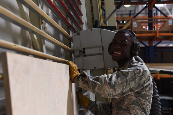 U.S. Airman Kokou Daglo, 39th Logistics Readiness Squadron inbound cargo journeyman, prepares to cut a board June 25, 2019, at Incirlik Air Base, Turkey. Along with inspecting items to determine serviceability, the cargo flight also constructs boxes for items that may require special handling during the shipping process. (U.S. Air Force photo by Staff Sgt. Matthew J. Wisher)