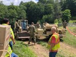West Virginia Army National Guard Soldiers provide welfare checks, water distribution, and debris removal in and around Harman, West Virginia, July 7, 2019 to assist residents who were affected by flooding June 30, 2019. The Soldiers have distributed 65 cases of water and boxes of food to residents as well as delivered two water buffalos to provide potable water.
