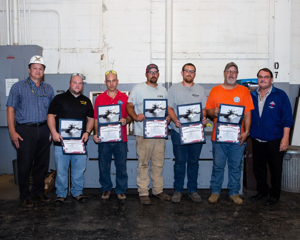 left: Chief Engineer Mark Everett, Matthew Newton, Cameron Hormachea, Joshua Bratton, Cordero Cooper, Russell Murphy, and Mechical Engineering Technician Bob Damico celebrate efforts on emergent repairs. RIGHT: Chief Test Engineer Mark Everett speaks with the Diesel Shop about their efforts in the USS Ohio (SSGN 726) Emergency Diesel Generator Repair Efforts.
