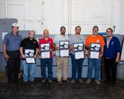 left: Chief Engineer Mark Everett, Matthew Newton, Cameron Hormachea, Joshua Bratton, Cordero Cooper, Russell Murphy, and Mechical Engineering Technician Bob Damico celebrate efforts on emergent repairs. RIGHT: Chief Test Engineer Mark Everett speaks with the Diesel Shop about their efforts in the USS Ohio (SSGN 726) Emergency Diesel Generator Repair Efforts.