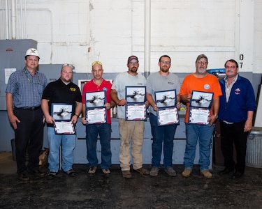 left: Chief Engineer Mark Everett, Matthew Newton, Cameron Hormachea, Joshua Bratton, Cordero Cooper, Russell Murphy, and Mechical Engineering Technician Bob Damico celebrate efforts on emergent repairs. RIGHT: Chief Test Engineer Mark Everett speaks with the Diesel Shop about their efforts in the USS Ohio (SSGN 726) Emergency Diesel Generator Repair Efforts.