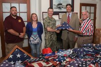 Norfolk Naval Shipyard Commander Captain Kai Torkelson presents 175 flags to Robie Gardner of Sturtevant Funer Home, Portsmouth, Va.