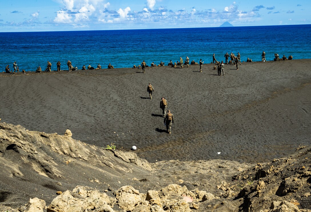 Marines and Sailors of 7th Communication Battalion arrive to the beaches of Iwo Jima, Japan, July 2, 2019. The Marines and Sailors hiked in order to conduct a Professional Military Education on the Battle of Iwo Jima. Through the hike the Marines and sailors were able to learn and experience some of the history of the Battle of Iwo Jima.