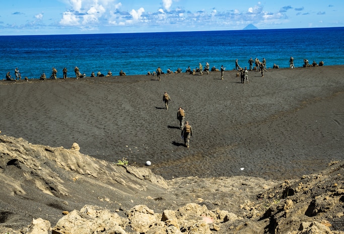 Marines and Sailors of 7th Communication Battalion arrive to the beaches of Iwo Jima, Japan, July 2, 2019. The Marines and Sailors hiked in order to conduct a Professional Military Education on the Battle of Iwo Jima. Through the hike the Marines and sailors were able to learn and experience some of the history of the Battle of Iwo Jima.