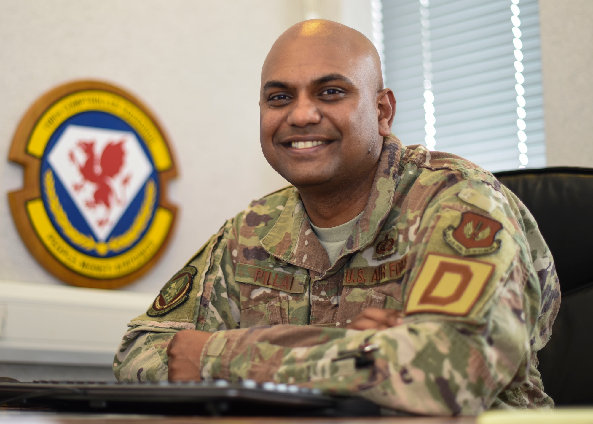 U.S. Air Force Maj. Triven Pillai in his office at RAF Mildenhall, England, June 17, 2019. Pillai earned three degrees from Washington State University while running his own business and working 40 hours per week. (U.S. Air Force photo by Airman 1st Class Joseph Barron)