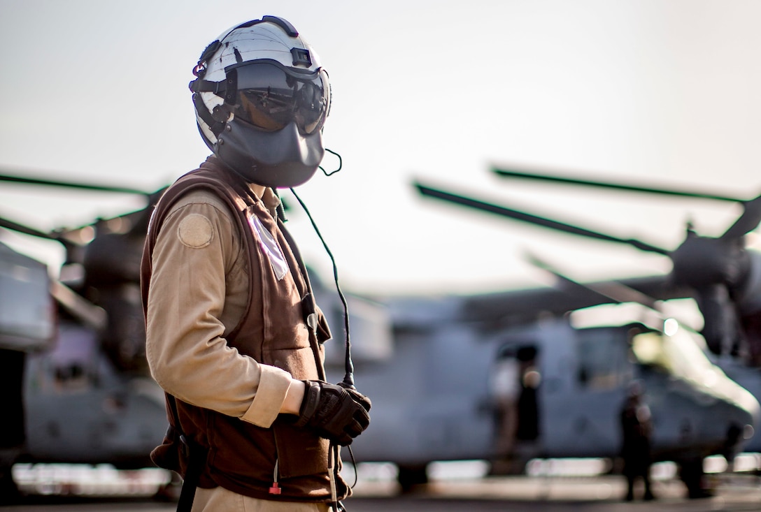 U.S. Marine Corps Cpl. Jia Wu, an MV-22 Osprey crew chief with Marine Medium Tiltrotor Squadron 163, 11th Marine Expeditionary Unit, stands on the flight deck of the amphibious assault ship USS Boxer during flight operations. The Boxer Amphibious Ready Group and the 11th MEU are deployed to the U.S. 5th Fleet area of operations in support of naval operations to ensure maritime stability and security in the Central Region, connecting the Mediterranean and the Pacific through the Western Indian Ocean and three strategic choke points.