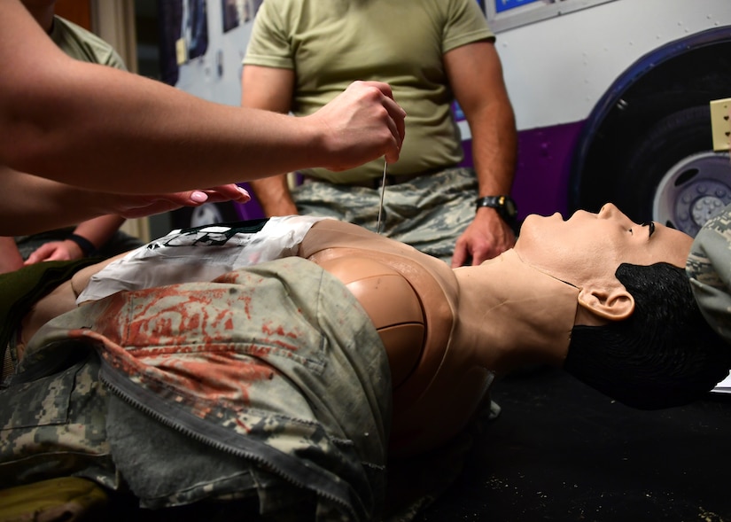 Airmen from the 911th Airlift Wing perform a medical procedure on a mechanical mannequin at Fort Indiantown Gap, Pennsylvania June 19, 2019. During the week-long training at Fort Indiantown Gap, the medical personnel trained on several different procedures using the mechanical mannequins. (U.S. Air Force photo by Senior Airman Grace Thomson)