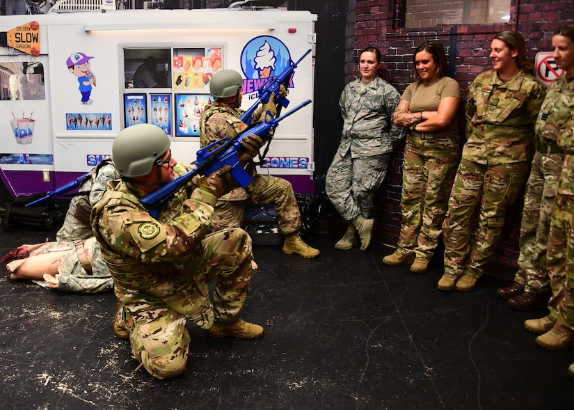 Maj. Paul Blycheck, flight nurse with the 911th Aeromedical Evacuation Squadron, and Senior Master Sgt. David Miller, functional manager with the 911th Aeromedical Staging Squadron, act out a possible combat scenario for Airmen from the 911th Airlift Wing at Fort Indiantown Gap, Pennsylvania June 19, 2019. The instructors acted out the combat scenario to give the students a better understanding of the scenario they would be doing the next day. (U.S. Air Force photo by Senior Airman Grace Thomson)