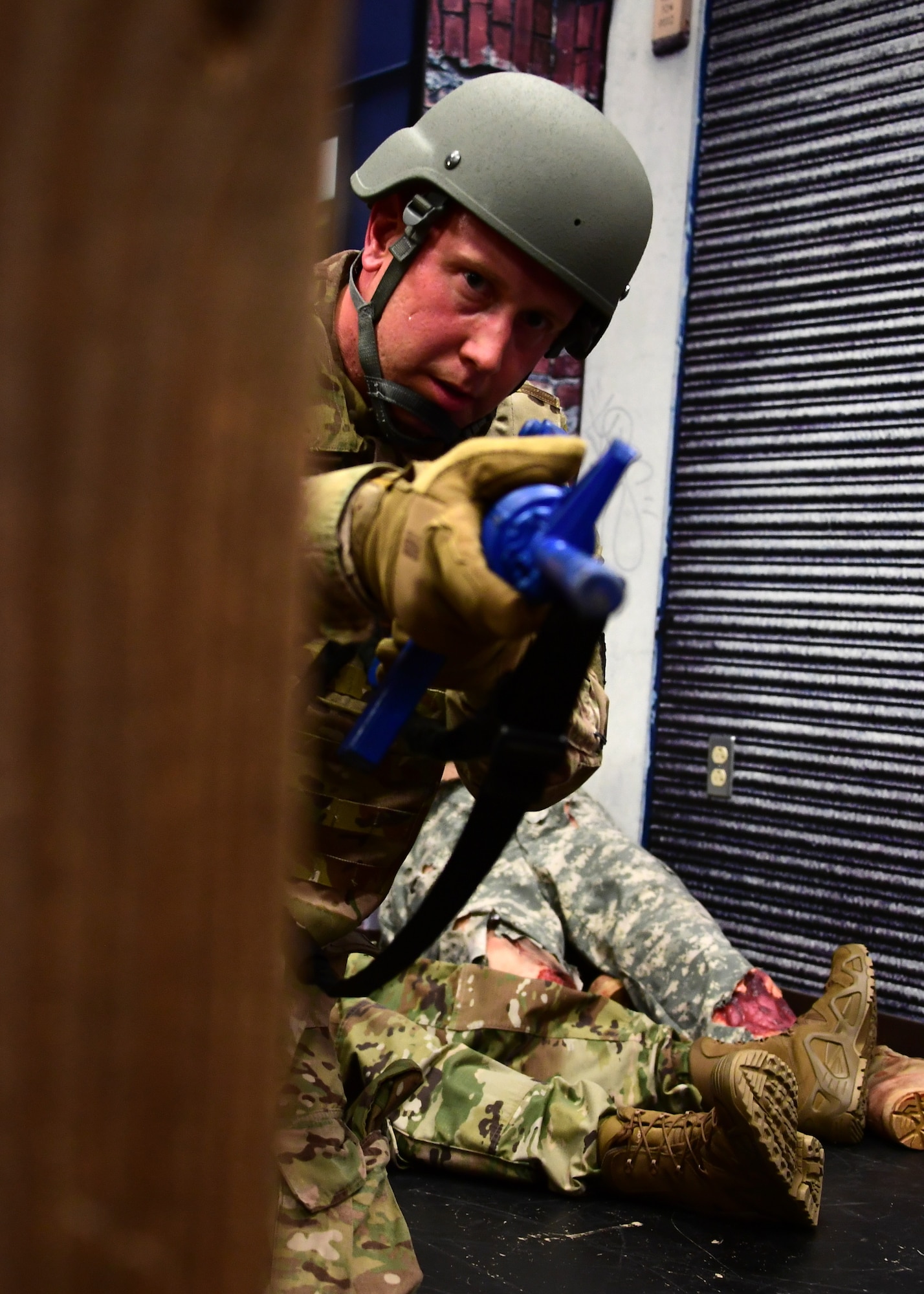 Senior Master Sgt. David Miller, functional manager with the911th Aeromedical Staging Squadron, provides cover in a simulation at Fort Indiantown Gap, Pennsylvania, June 19, 2019. During the simulation, the instructors performed a scenario similar to one the students would be in the next day in order to better prepare them for the training. (U.S. Air Force photo by Senior Airman Grace Thomson)