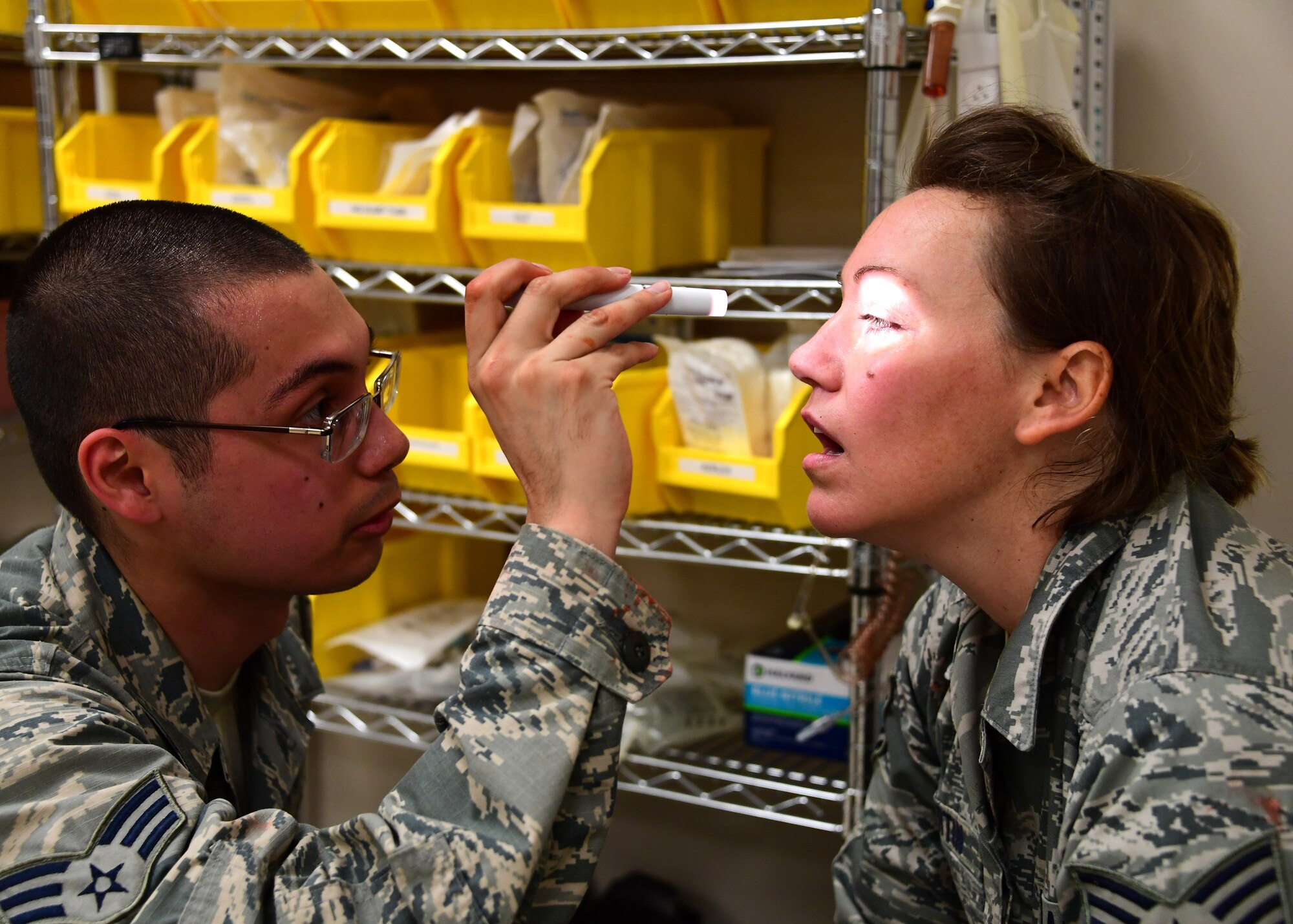 Senior Airman Luke Block, medical technician with the 911th Aeromedical Staging Squadron, simulates an assessment of Tech Sgt. Nicole Martin, aerospace medical technician with the 911th ASTS, during a simulation at Fort Indiantown Gap, Pennsylvania, June 20, 2019. Martin was acting as a concussed Airman for the simulation and had to be attended to to by the students. (U.S. Air Force photo by Senior Airman Grace Thomson)