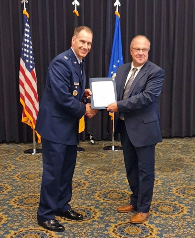 man is presented an award