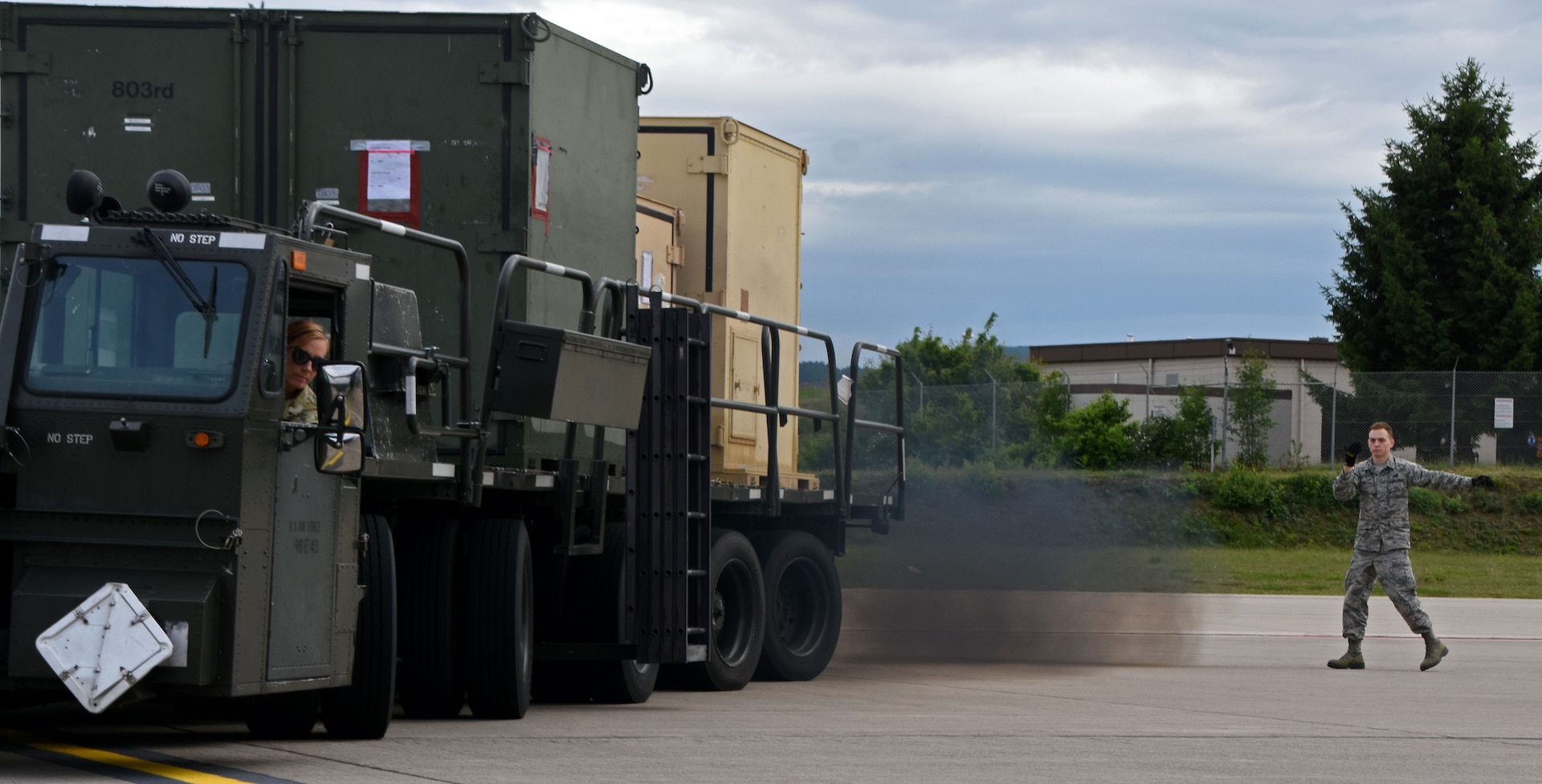 Senior Airman Timothy Watson, 26th Aerial Port Squadron air transportation specialist, guides Staff Sgt. Michelle Grazier, 26th APS air transportation specialist, as she backs-up a K-loader, June 10, 2019, in preparation for exercise Swift Response 19, at Ramstein Air Base, Germany.