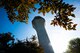 The air traffic control tower is seen through the trees