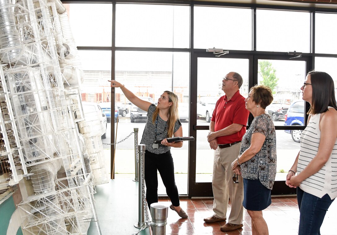 AEDC Tour Guide Deidre Ortiz, left, talks about the Propulsion Wind Tunnel facility June 10 during a tour for Bob Hyde, Annette Freres and Freres' daughter Michelle Freres at Arnold Air Force Base. Annette's father, Jack Durand, and stepfather, Col. Edwin Brown, both worked at Arnold. (U.S. Air Force photo by Jill Pickett) (This image has been altered by obscuring badges for security purposes.)