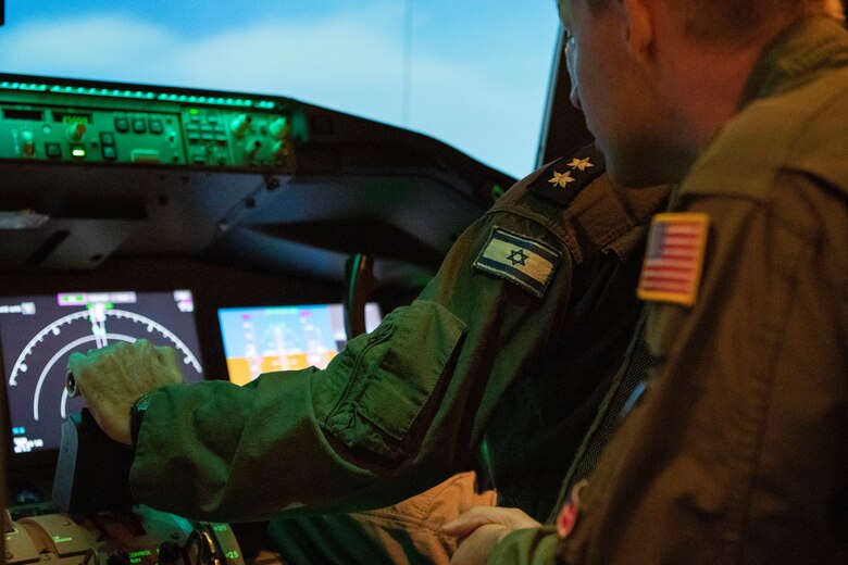With the help of an U.S. Air Force Airman, an Israeli air force Air Attaché to the United States of America member flies a KC-46A Pegasus flight simulator, July 1, 2019, at Altus Air Force Base, Okla. This was an opportunity to strengthen to U.S.-Israeli bilateral relationship while showcasing the home of the U.S. Air Force’s newest and most advanced tanker aircraft. (U.S. Air Force photo by Airman 1st Class Breanna Klemm)