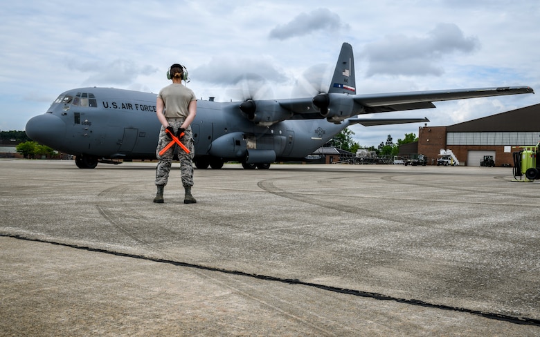 A Reserve Citizen Airman from Youngstown Air Reserve Station, marshalls the pilots on a C-130J Super Hercules June 19, 2019, on the flightline here.