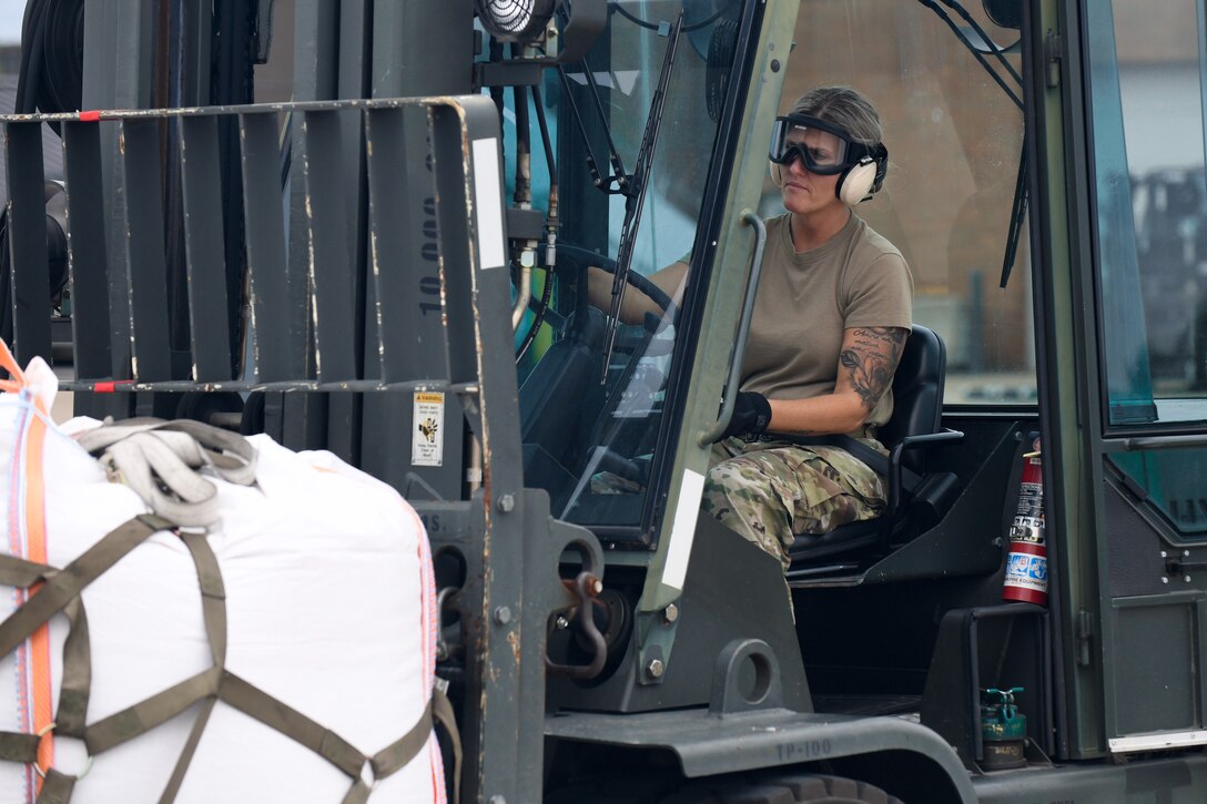 U.S. Air Force Tech. Sgt. Rebekah Sines, a motor vehicle operator with the 76th Aerial Port Squadron, transports humanitarian support cargo heading to Guatemala June 19, 2019, on the flightline here.