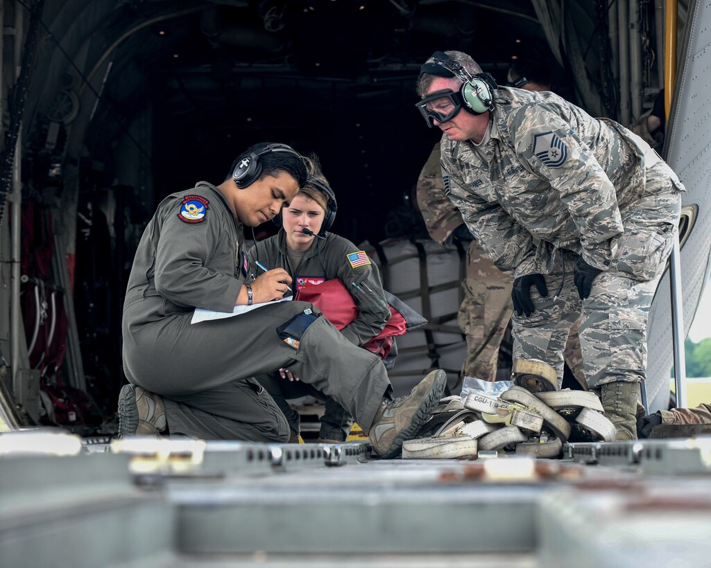 U.S. Air Force Airmen from Youngstown Air Reserve Station and Dyess Air Force Base, review documents on the back of a C-130J Super Hercules June 19, 2019, on the flightline at YARS.