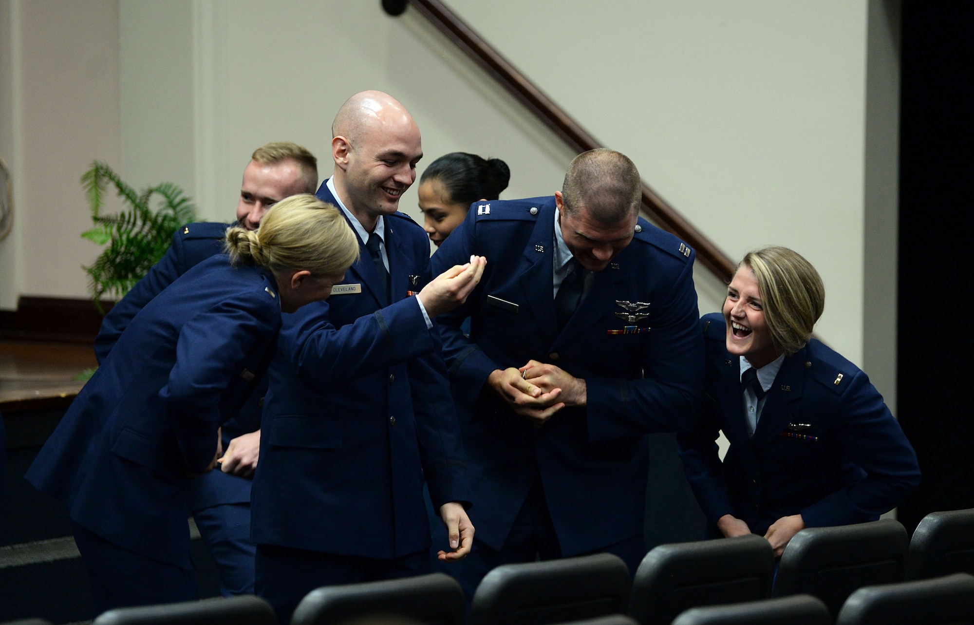 Graduates break their first set of wings following Specialized Undergraduate Pilot Training Class’s 19-17/18 graduation in the Kaye Auditorium June 28, 2019, on Columbus Air Force Base, Miss. Breaking of the wings is a tradition for new pilots, as one half is kept by the pilot and the other by a loved one. The two halves are not brought together until the pilot’s death. (U.S. Air Force photo by Airman Hannah Bean)