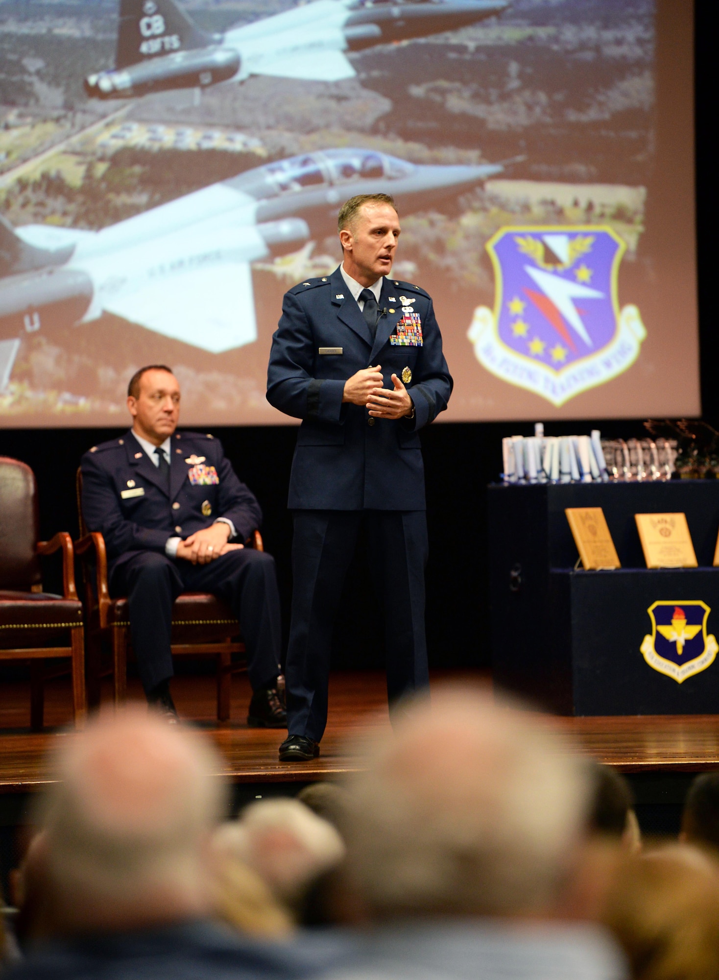 Retired Brig. Gen. John Cherrey, former Director of Intelligence, Operations and Nuclear Integration, Headquarters Air Education and Training Command at Joint Base San Antonio-Randolph, Texas, speaks to attendees during Specialized Undergraduate Pilot Training Class’s 19-17/18 graduation in the Kaye Auditorium June 28, 2019, on Columbus Air Force Base, Miss. Cherrey spoke about his last 30 years as a pilot and wanted the newest generation of aviators to understand how important their job is. (U.S. Air Force photo by Airman Hannah Bean)