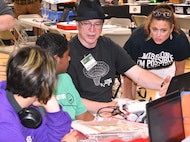 IMAGE: KING GEORGE. Va. (June 26, 2019) - Middle school students are briefed by their science, technology, engineering, and mathematics (STEM) mentors – a Navy mathematician, center, and a Middle School teacher - at the 2019 Naval Surface Warfare Center Dahlgren Division (NSWCDD) STEM Summer Academy, held June 24-28. They were among 70 middle school students who developed their teamwork and problem-solving skills in math and science while partnering with a teacher and an NSWCDD scientist or engineer. The STEM Summer ‘campers’ deployed the robots they designed, built, and programmed to respond to 10 missions - including the delivery of humanitarian aid, rotating troops and transporting an electromagnetic railgun to the deck of a Navy ship – by the end of the week-long academy.