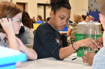 IMAGE: KING GEORGE. Va. (June 26, 2019) – A middle school student prepares for an aerospace engineering rocketry activity at the 2019 Naval Surface Warfare Center Dahlgren Division (NSWCDD) science, technology, engineering, and mathematics (STEM) Summer Academy, held June 24-28. She was among 70 middle school students who constructed and calibrated their water rockets while discovering the optimal amount of fuel (water) to launch a ball the highest. The STEM Summer ‘campers’ worked in teams to organize and analyze their data in order to determine what fuel volume will result in the highest launch.