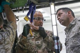 U.S. Army Staff Sgt. Jose Medina, 1106th Aviation Group, explains how fabricated sheet metal should align to the beam of a UH-60 Blackhawk helicopter to 2nd Lt. Raad Alzubi, Royal Jordanian Air Force, during a recent UH-60 Blackhawk subject matter expert exchange at the King Abdullah II Air Base in Amman, Jordan, June 19, 2019.