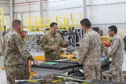 Lt. Col. Richard Brummond, Task Force Spartan, observes a part fabricated by Royal Jordanian Air Force that will go on a UH-60 Blackhawk helicopter during an aviation subject matter expert exchange at the King Abdullah II Air Base in Amman, Jordan, June 19, 2019.