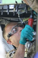 2nd Lt. Fareed Hailat, Royal Jordanian Air Force, drills a hole on a UH-60 Blackhawk helicopter during a subject matter expert exchange with the U. S. Army’s 1106th Aviation Group at the King Abdullah II Air Base in Amman, Jordan, June 19, 2019.